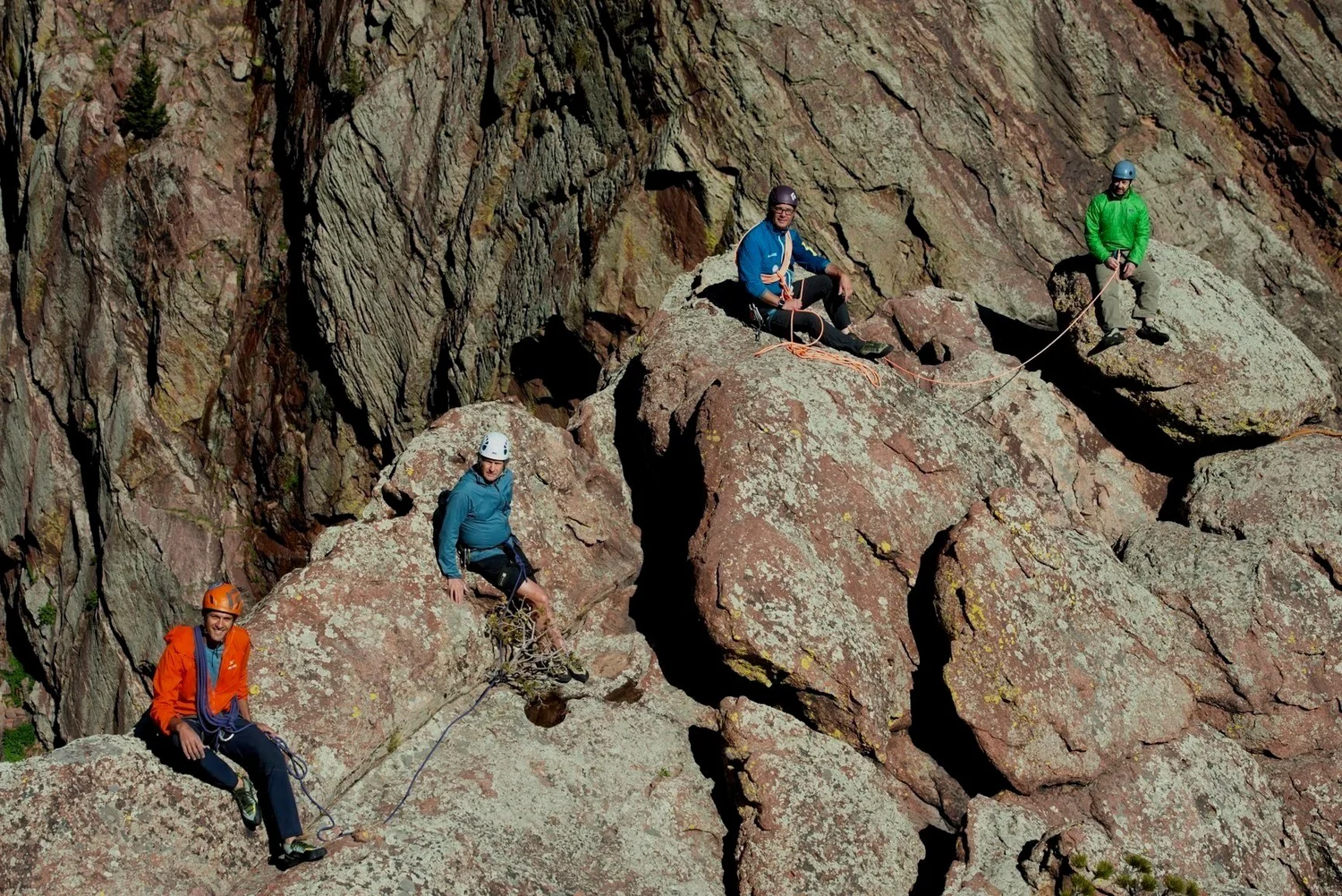 The four Boulder Ventures partners climbing on the red sandstone of the Flatirons